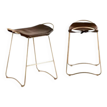 Brown stool pair without backrest with brass details.
