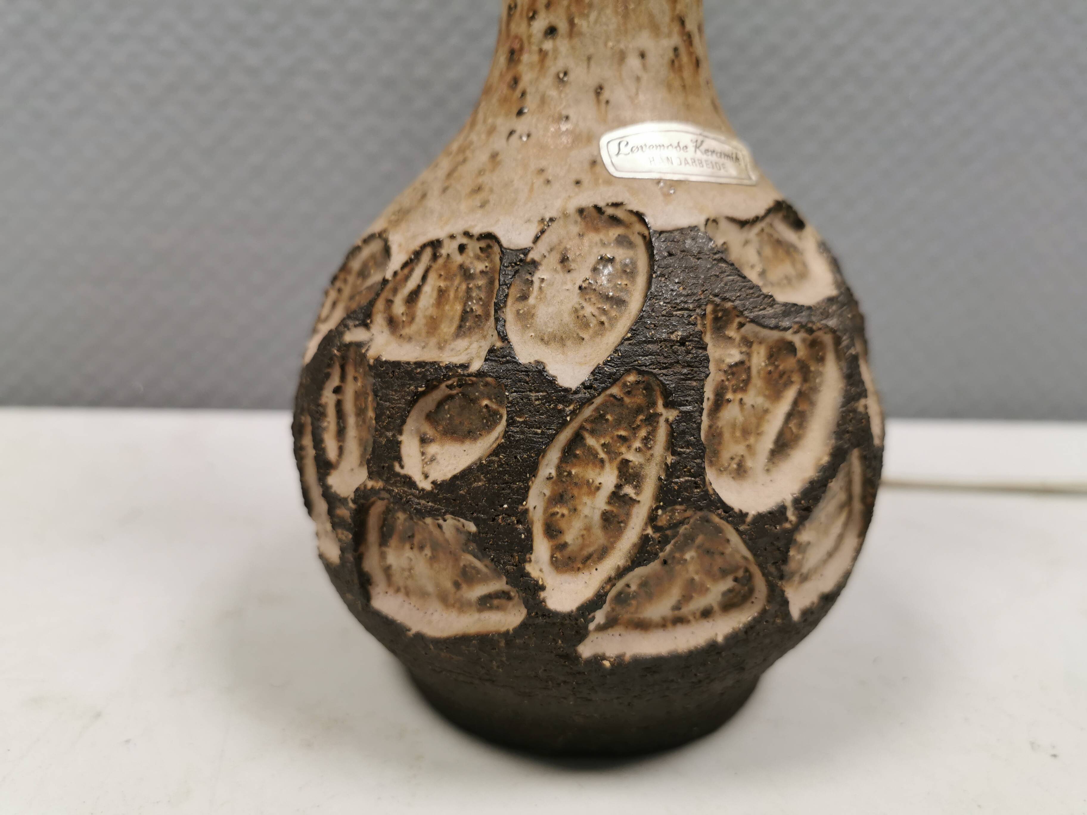 Small beautiful ceramic table lamp in earth colors.