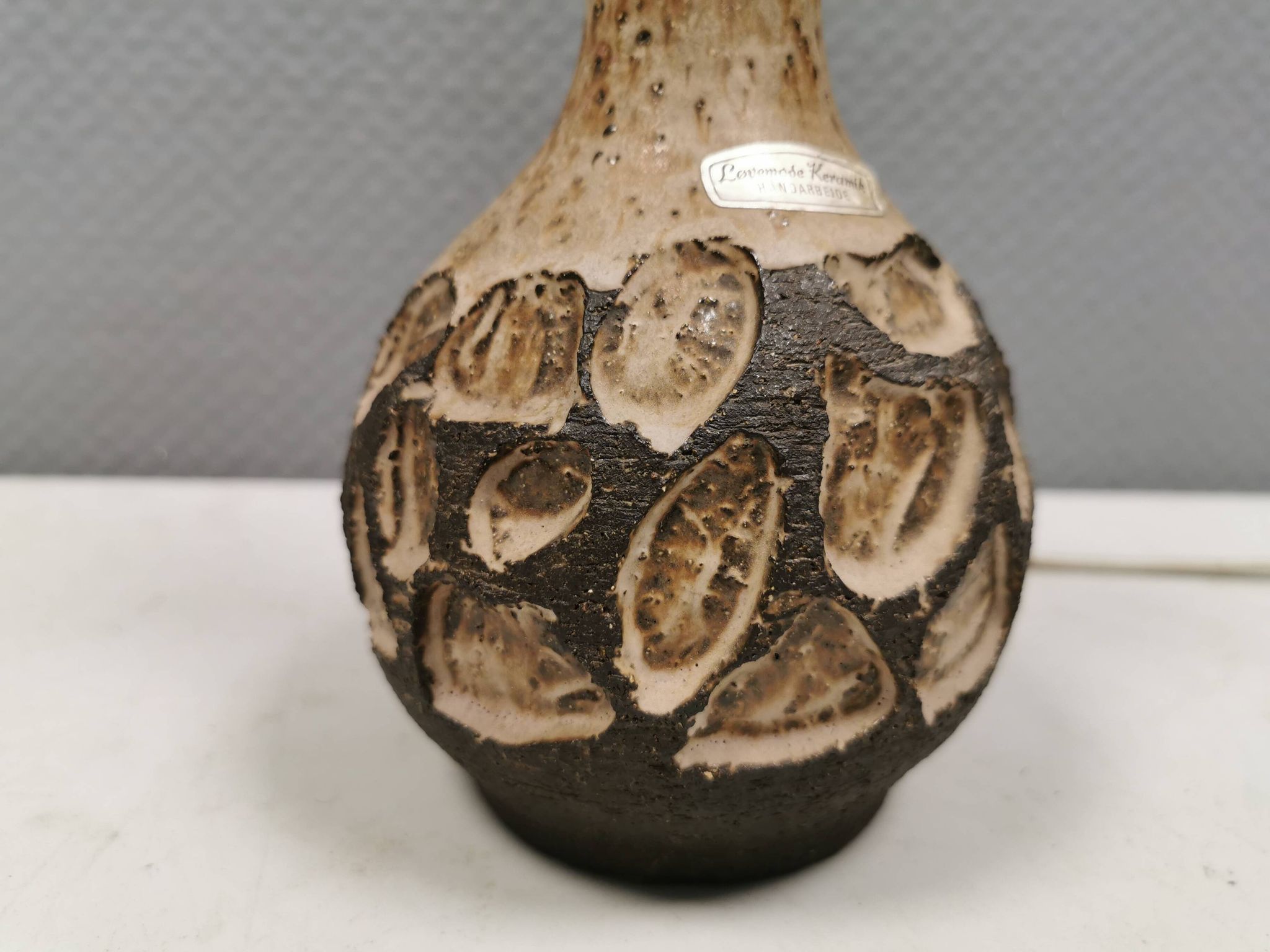 Small beautiful ceramic table lamp in earth colors.