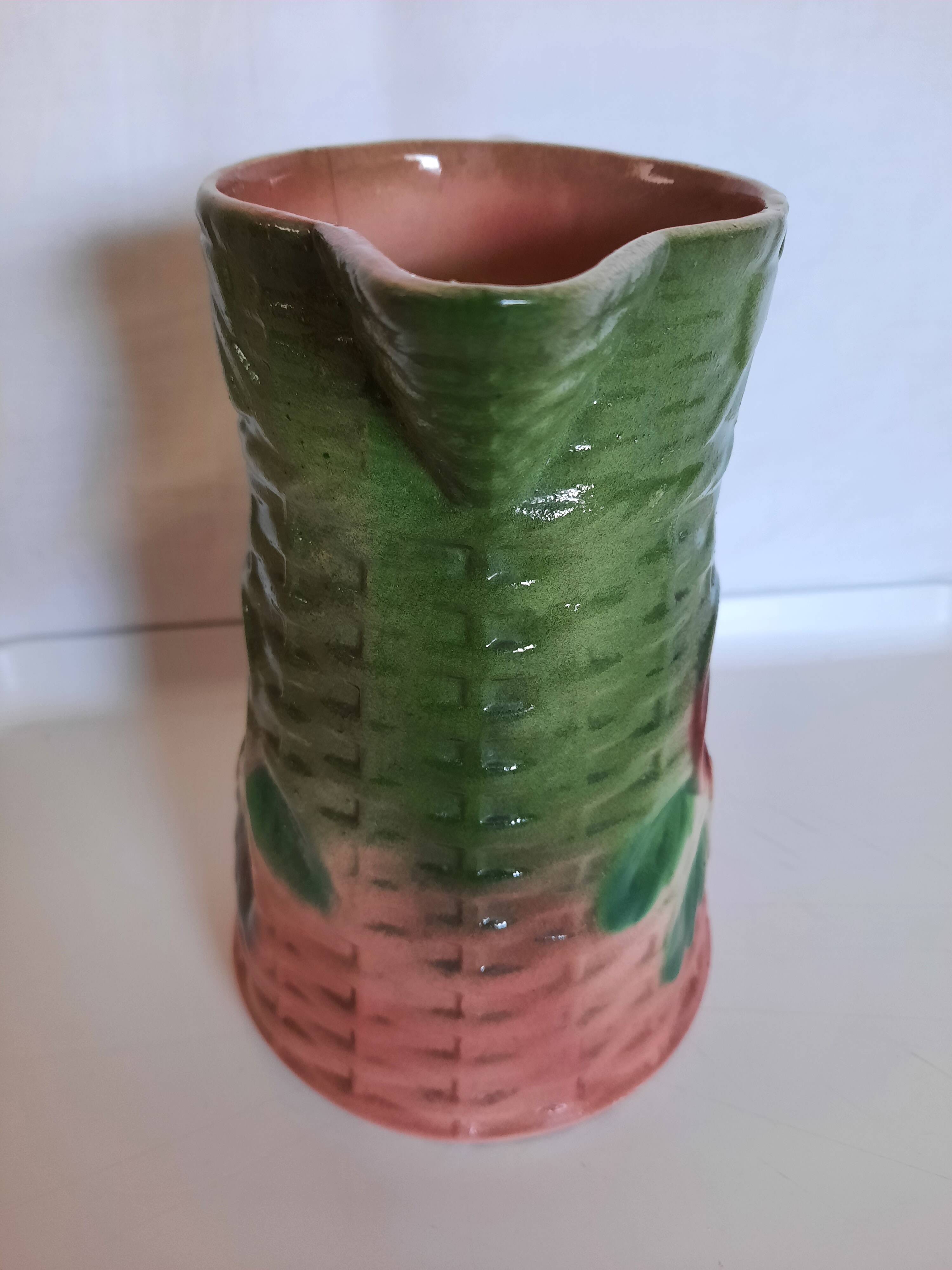Slush pitcher. Pansy pattern on wicker basket background. Green and pink.