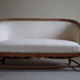 Sculptural 2-seater canapé in oak and wool, Danish "Skønvirke" style, 1920s.
