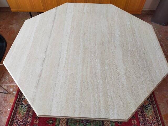 Octagonal dining table in travertine