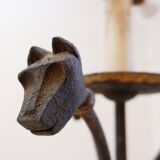 Wrought iron tripod floor lamp decorated with stylized animal heads