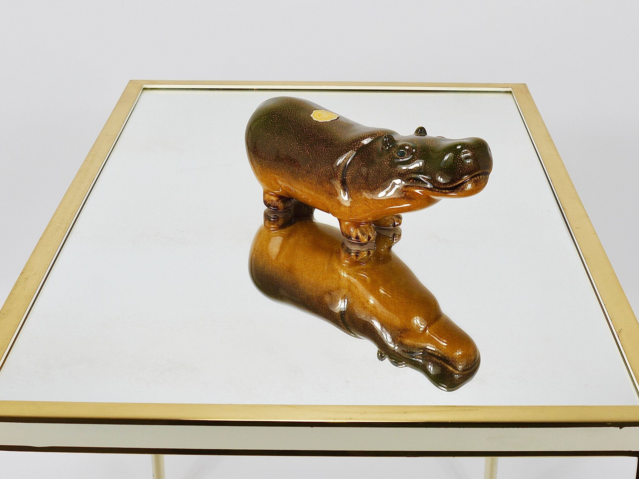 A pair of brass and white mirror tables from Vereinigte Werkstätten, Germany, 1970s.