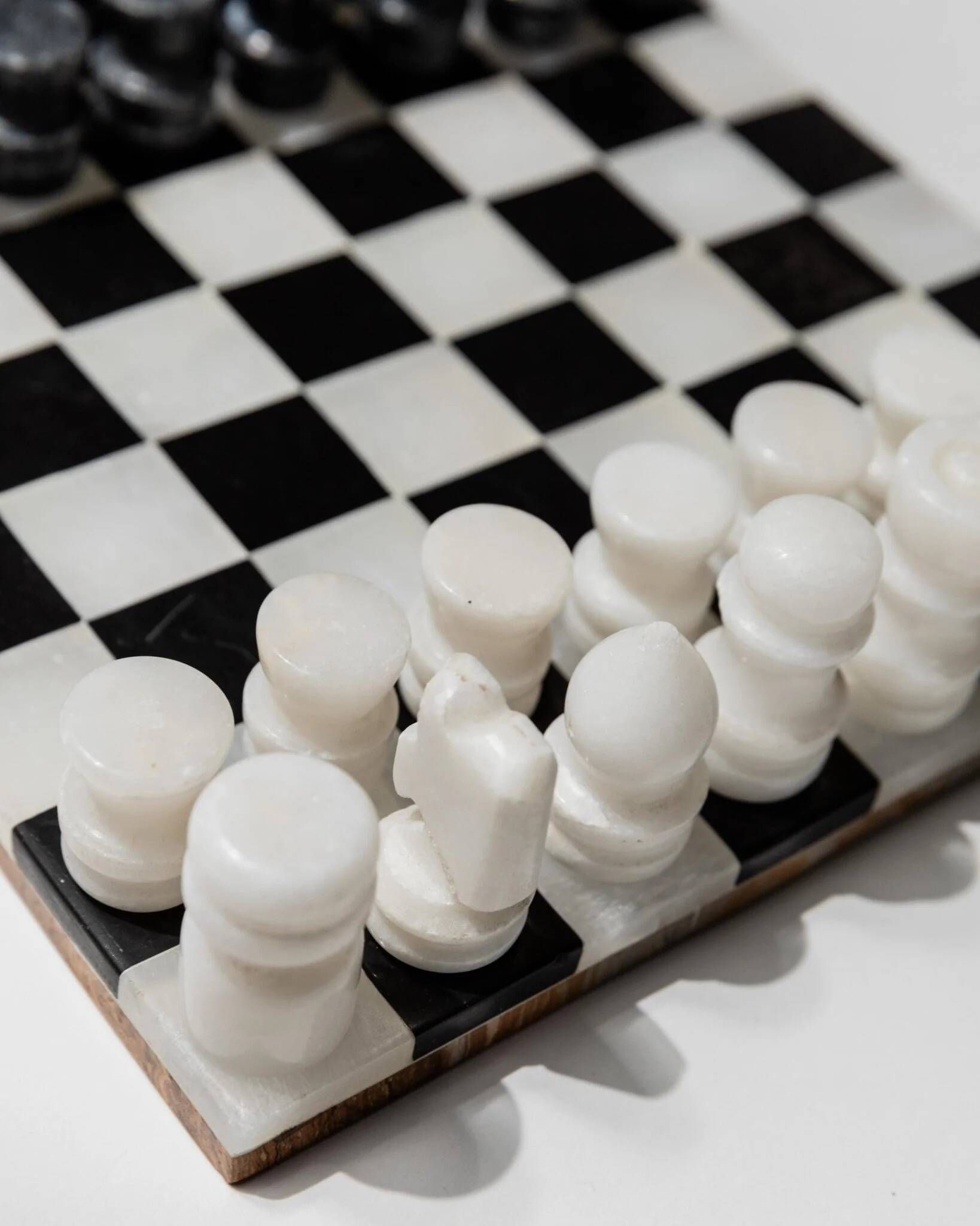 Vintage black-and-white marble chessboard with matching marble pieces, Italian 1960s design, sculptural centerpiece