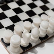 Vintage black-and-white marble chessboard with matching marble pieces, Italian 1960s design, sculptural centerpiece