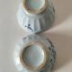 Two vintage farm bowls on a pale blue pedestal with floral decoration.