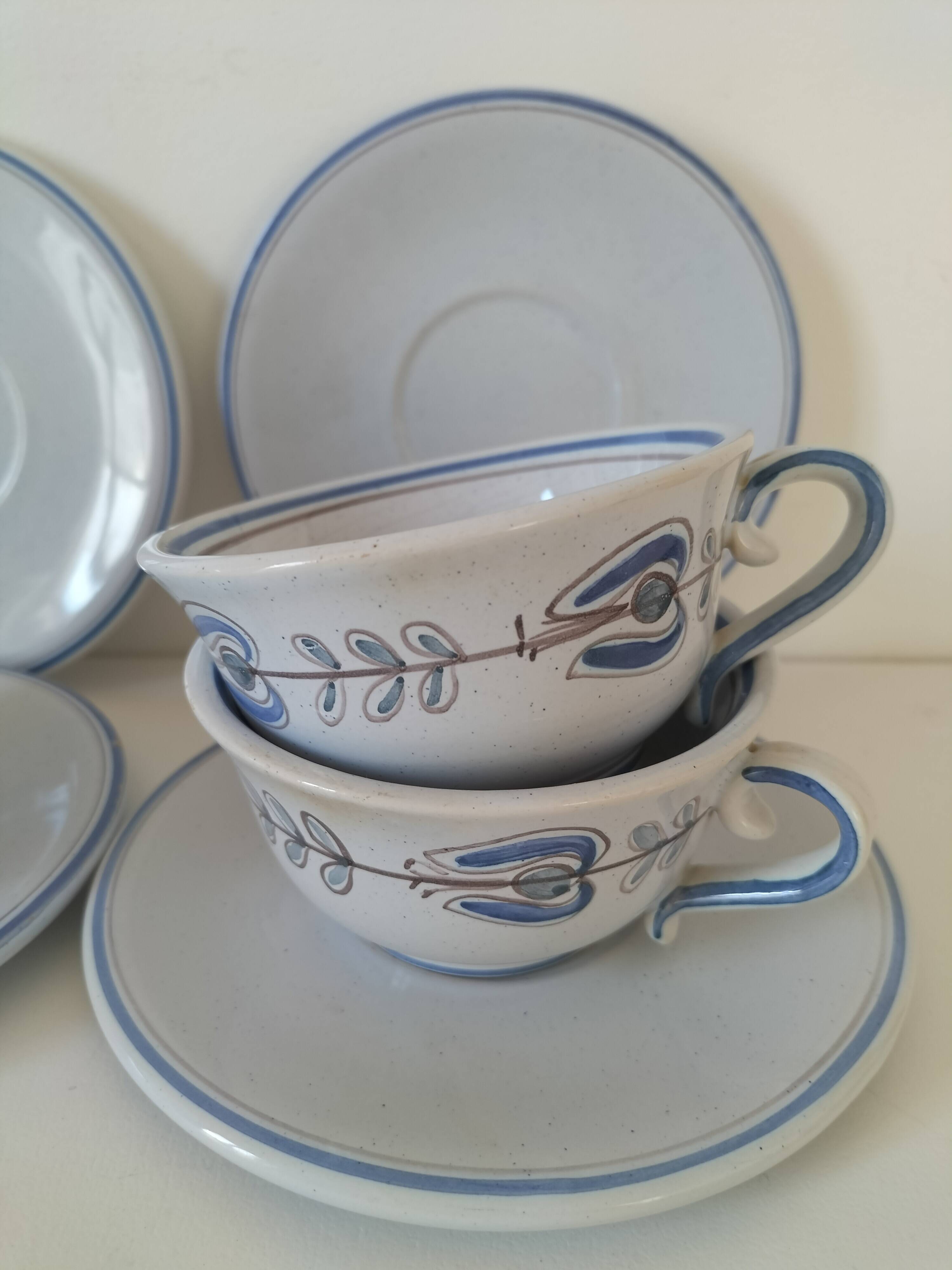 Glazed earthenware cups and saucers