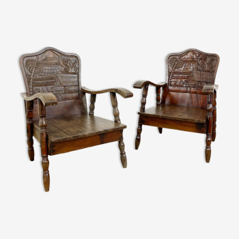Pair of carved teak wooden armchairs Indonesia
