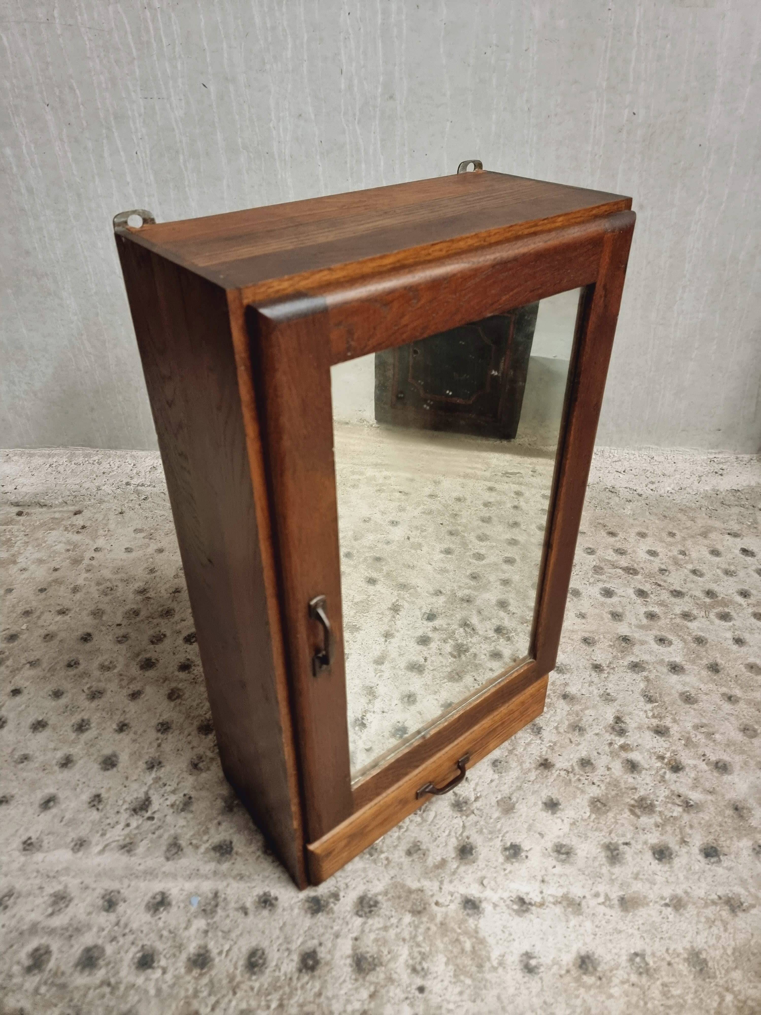 Old hanging cupboard medicine cabinet with mirror and drawer