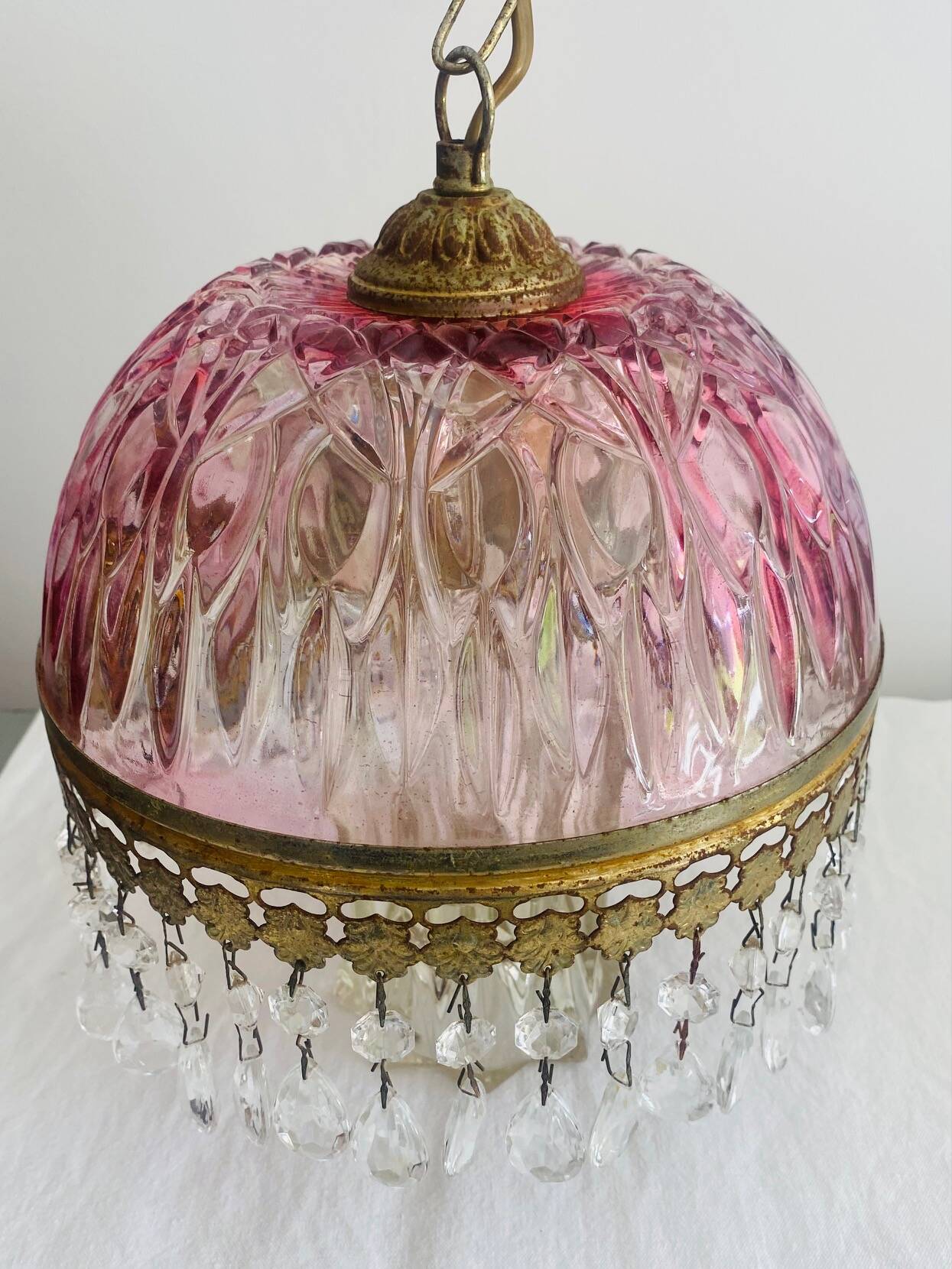 Antique pink glass pendant light with tassels.