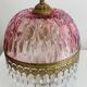 Antique pink glass pendant light with tassels.