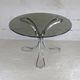 Table de séjour "Space Age" acier poli, dalle circulaire verre fumé. France, circa 1970.