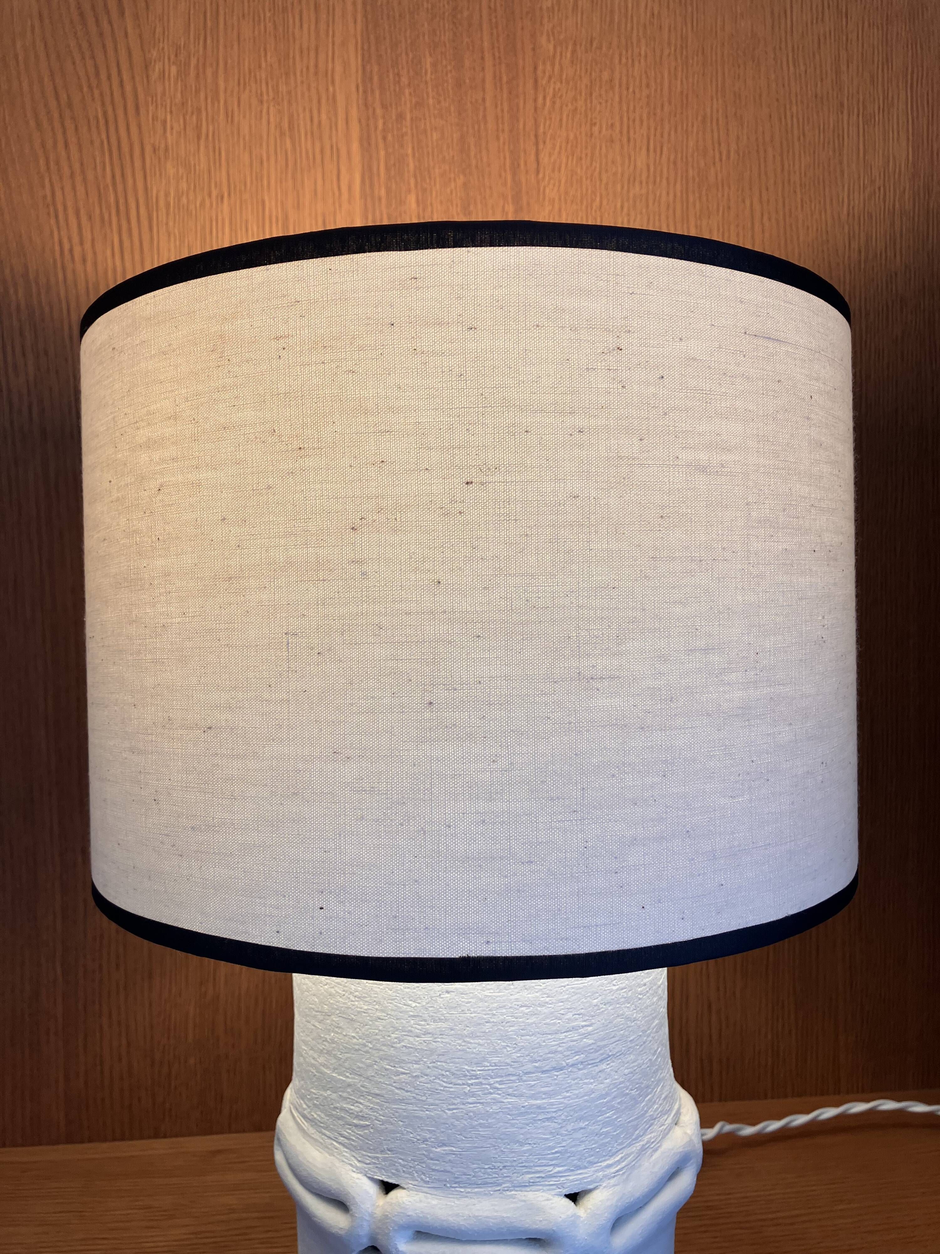 Table lamp in ceramic with a handmade couture-style lampshade from France.
