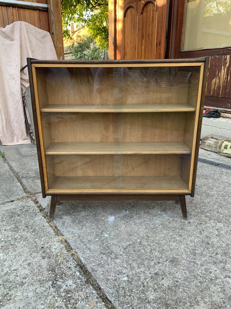 Mid-century brown wooden library (beech & pine) with glass doors from the 1960s.