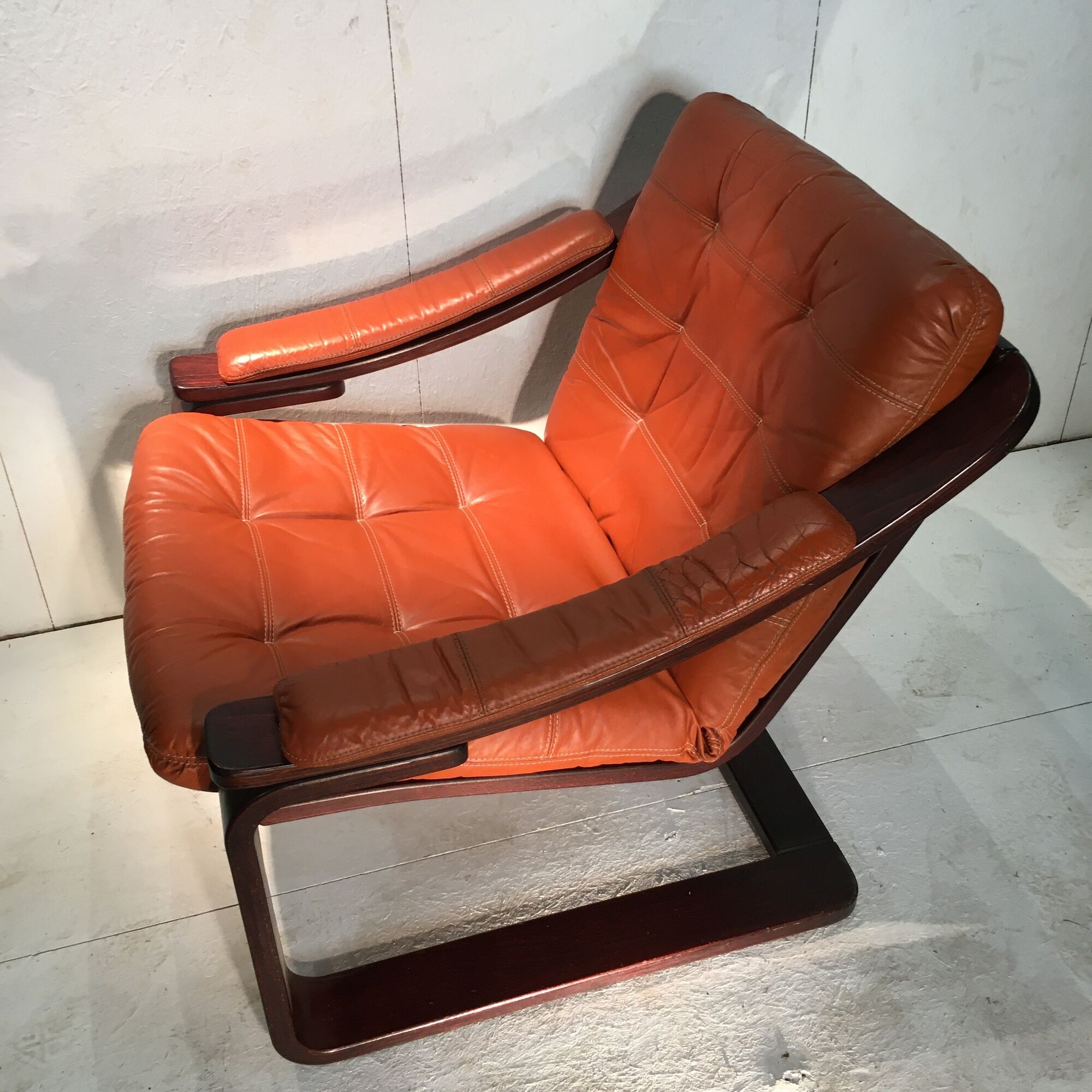 Duo of ochre leather and wood frame armchairs