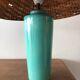 Enamelled ceramic lamp and rattan