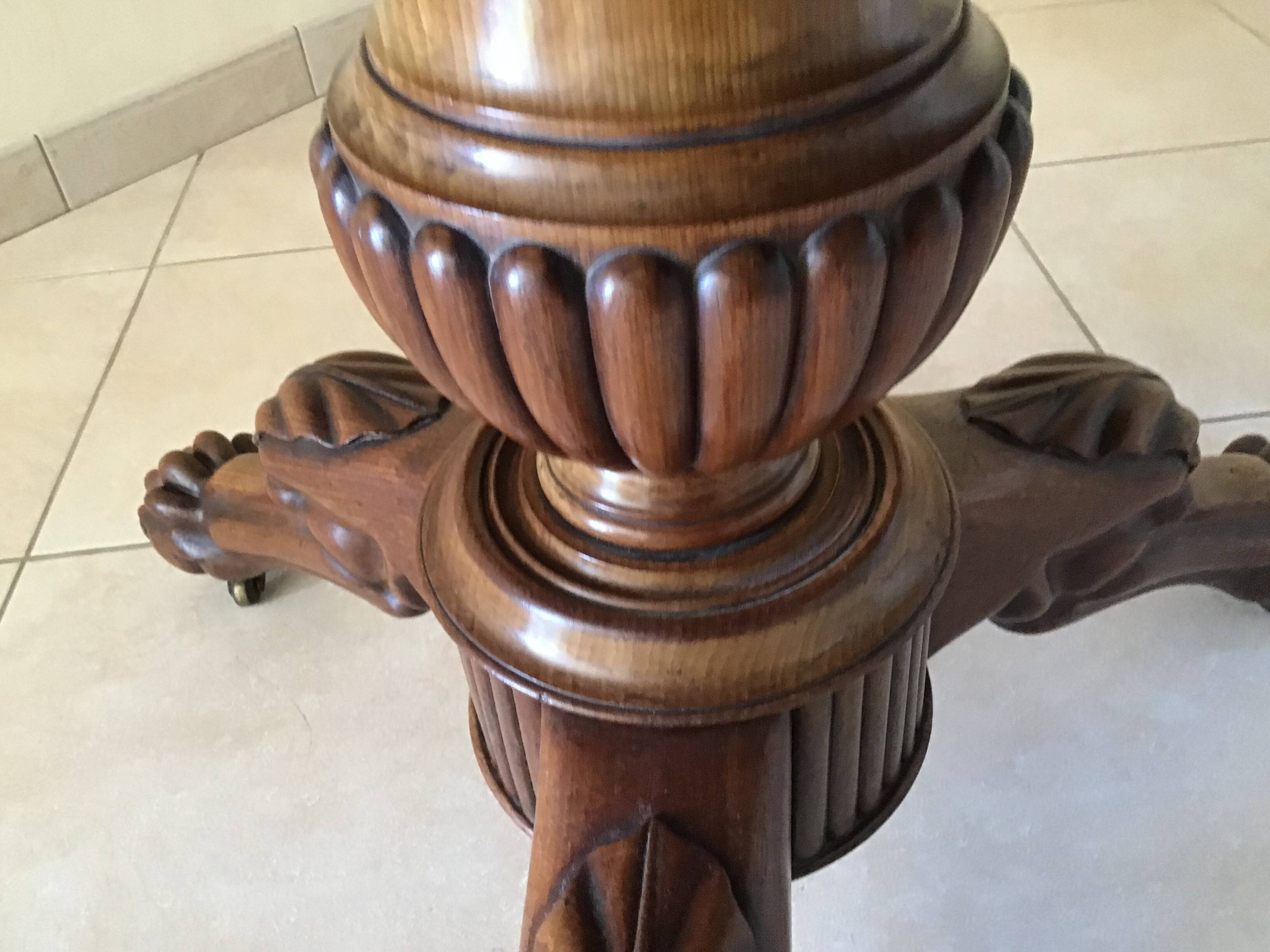 Wooden gueridon with marble, lion paw legs.