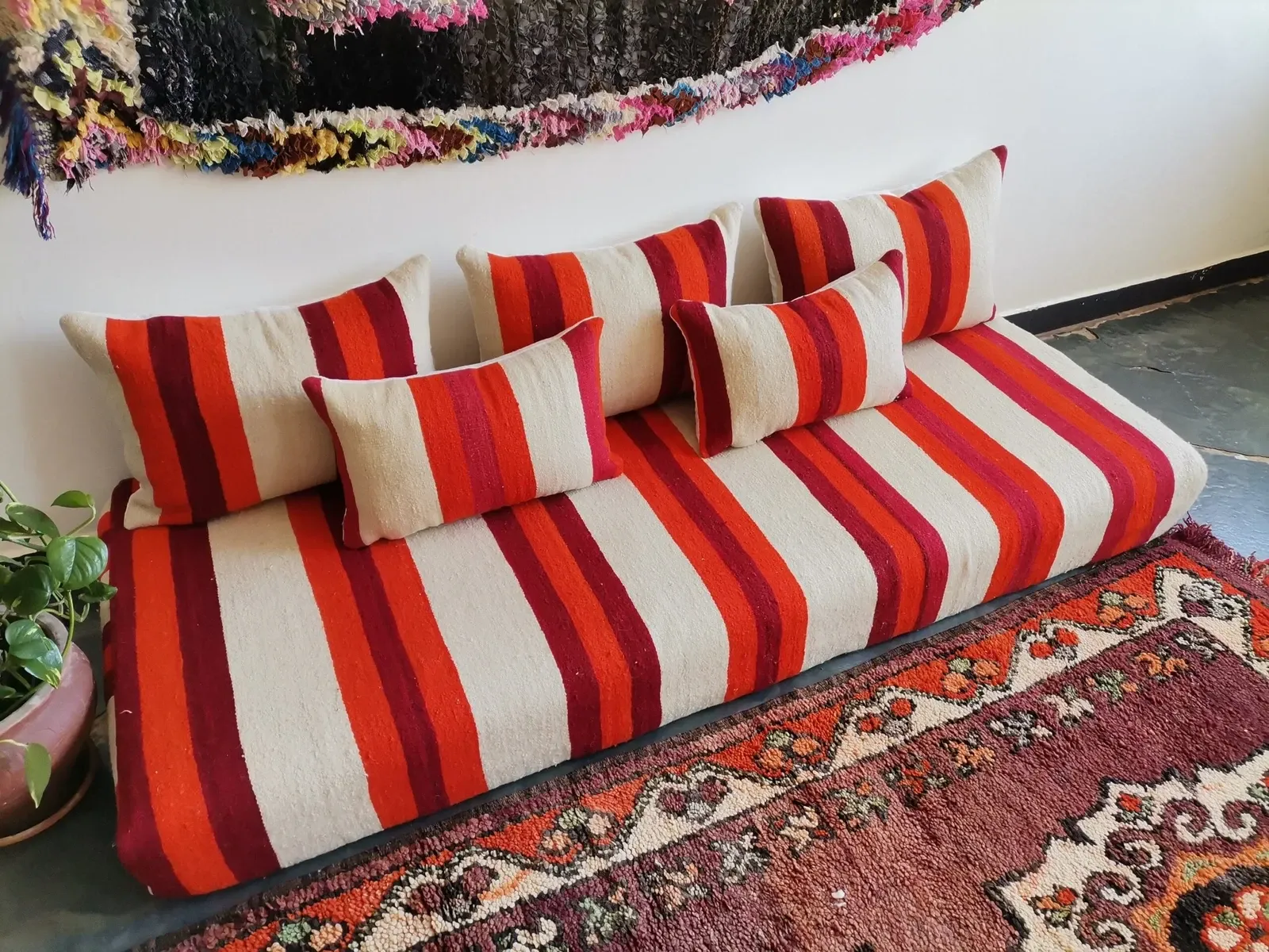 Set of covers for cream and red Moroccan floor sofa.