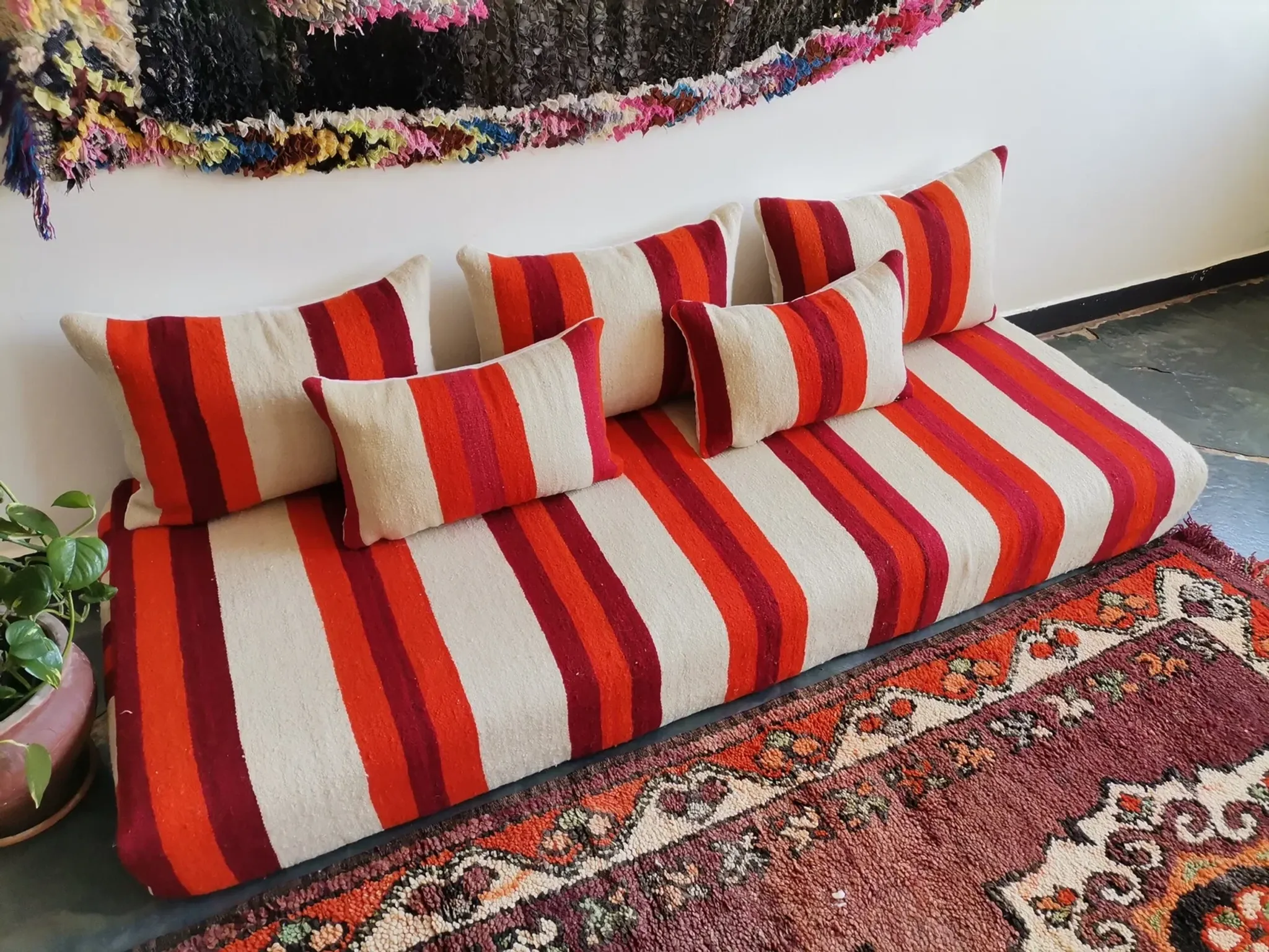Set of covers for cream and red Moroccan floor sofa.