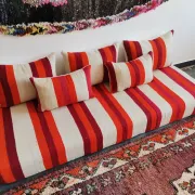 Set of covers for cream and red Moroccan floor sofa.