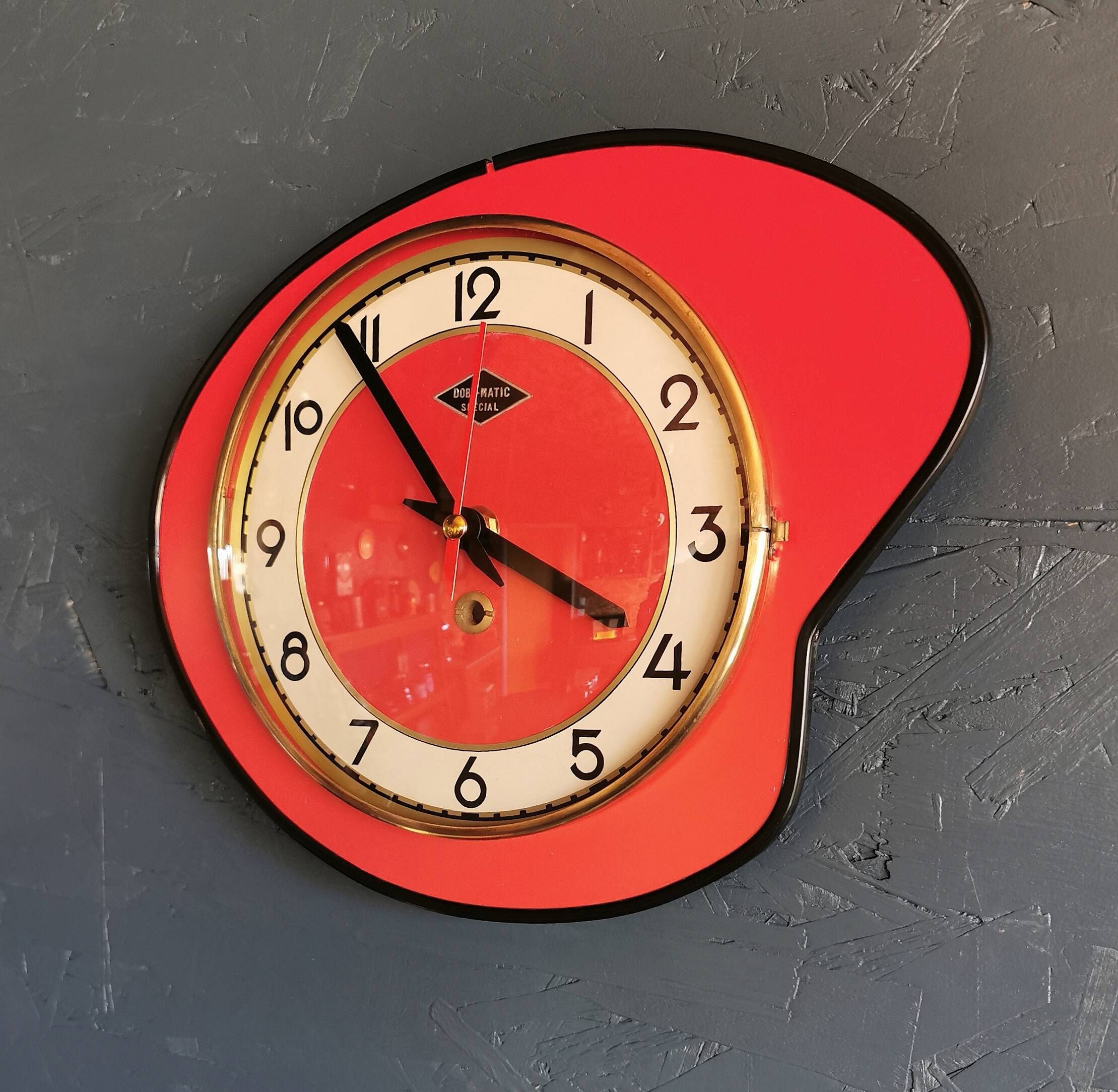 Vintage formica clock silent asymmetrical wall pendulum "Doby Matic red"