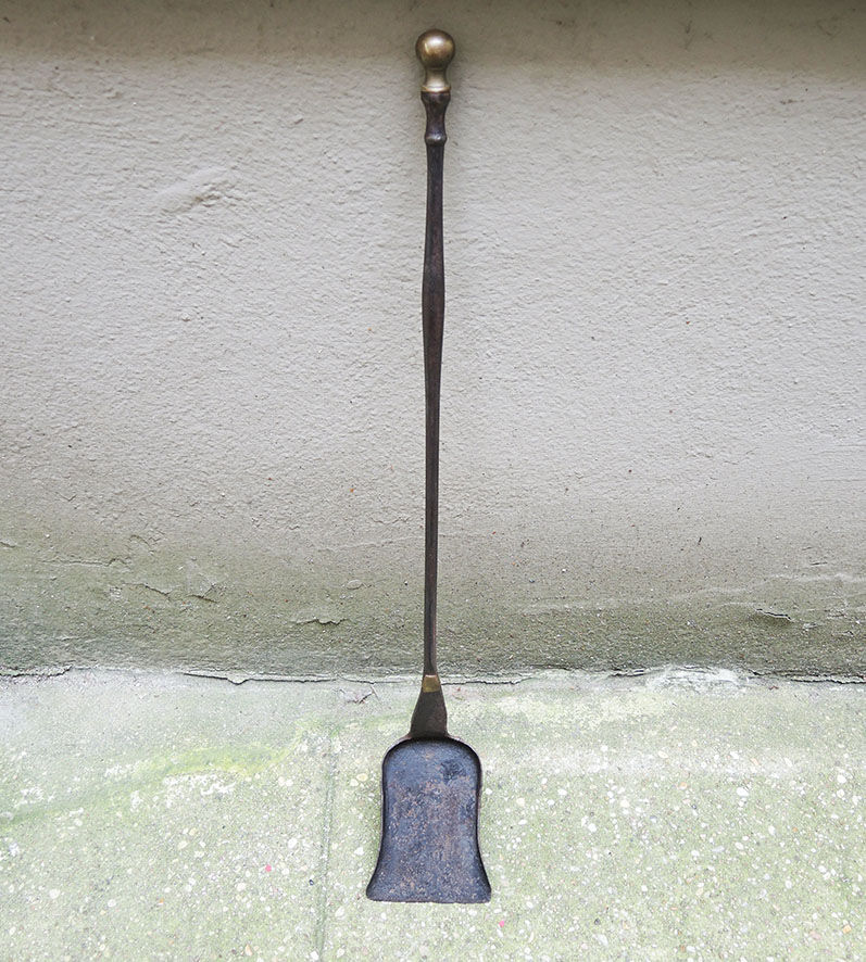 Old chimney shovel in wrought iron and brass