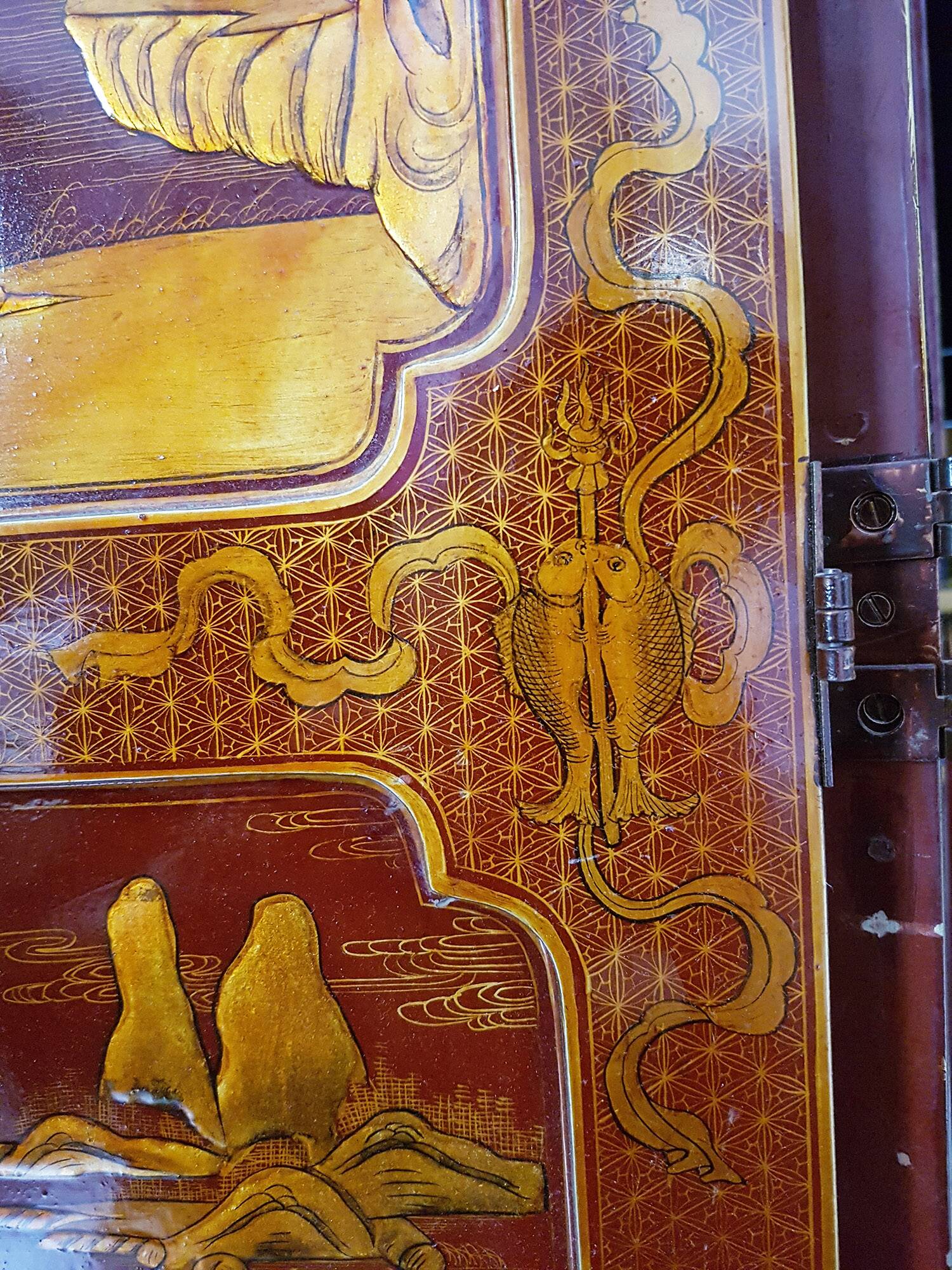Four-panel Japanese-style screen in red and gold lacquer.