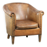 Vintage sheepskin club armchair finished with decorative nails