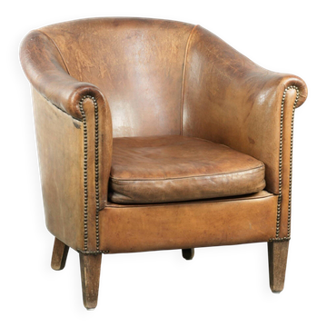Vintage sheepskin club armchair finished with decorative nails