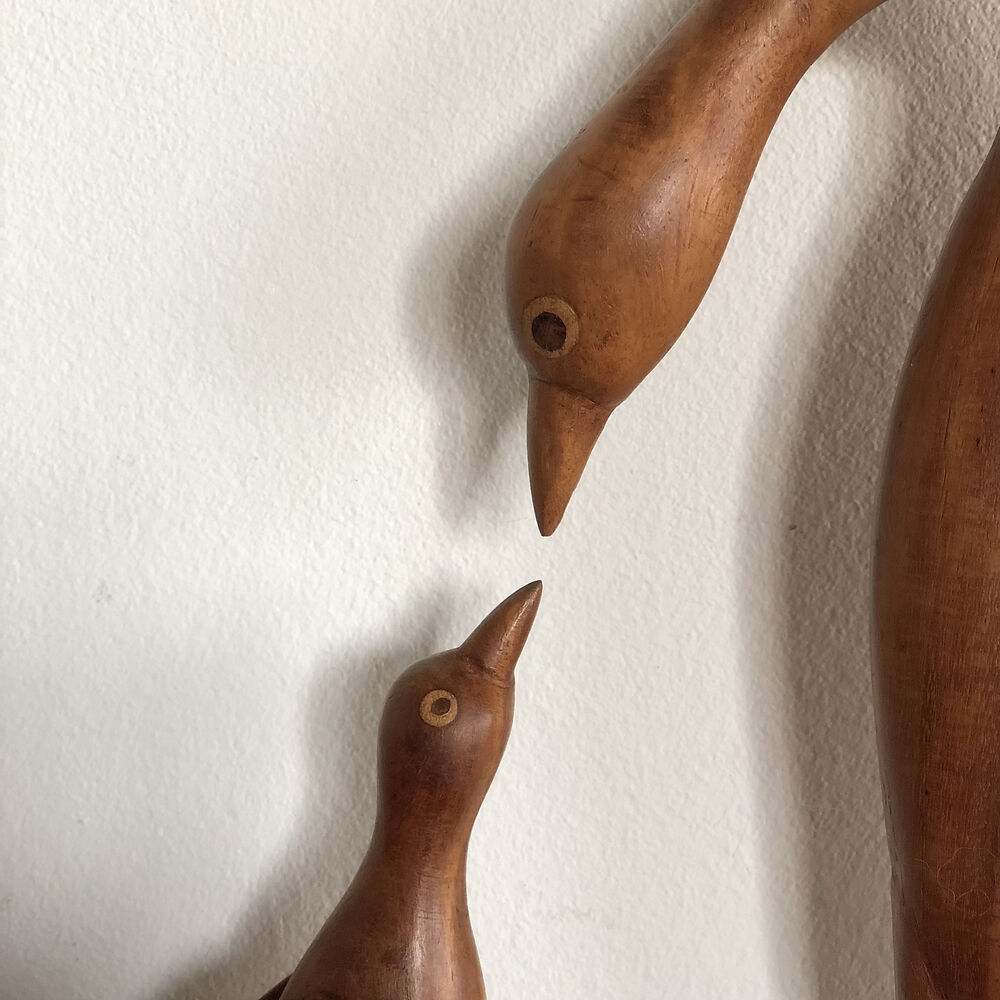 Sculpture of a goose feeding its young