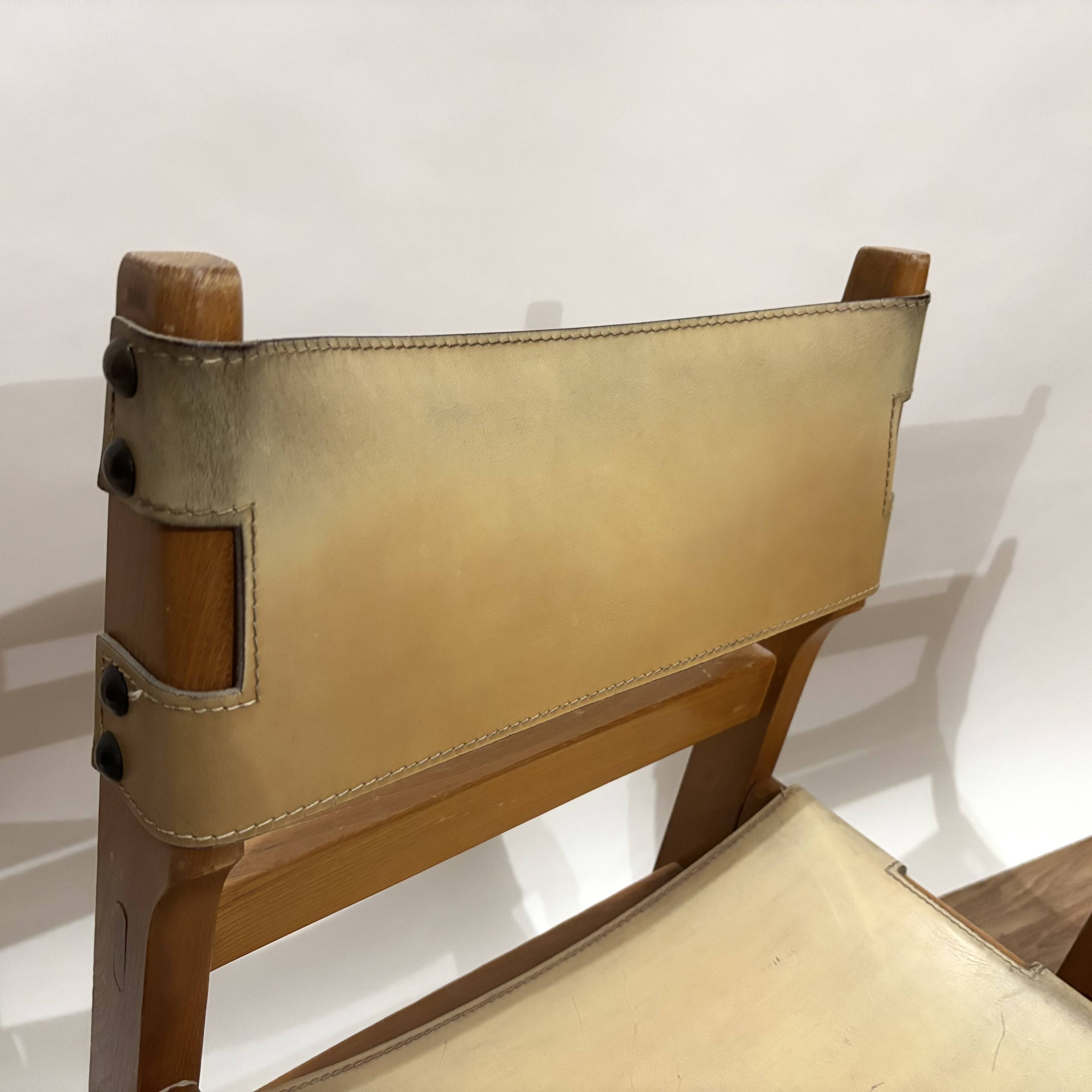Pair of Maison Regain leather chairs