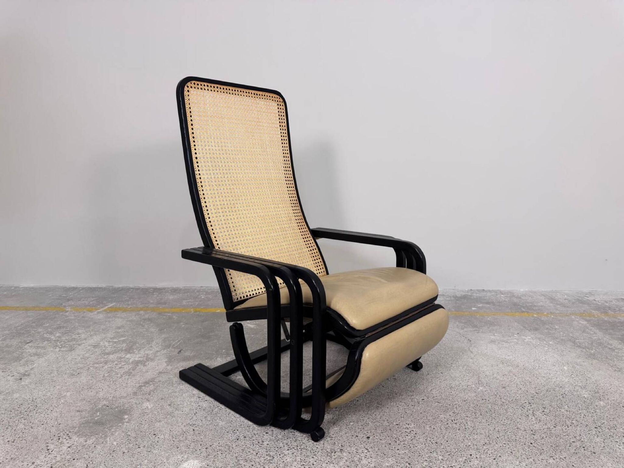 Rocking lounge chair, curved wood, leather, Viennese cane design.