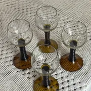 Footed glasses of the Roemer type, amber colour