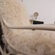 Antique Thonet rocking chair in ivory lacquered bent wood, with a white lamb fur seat.