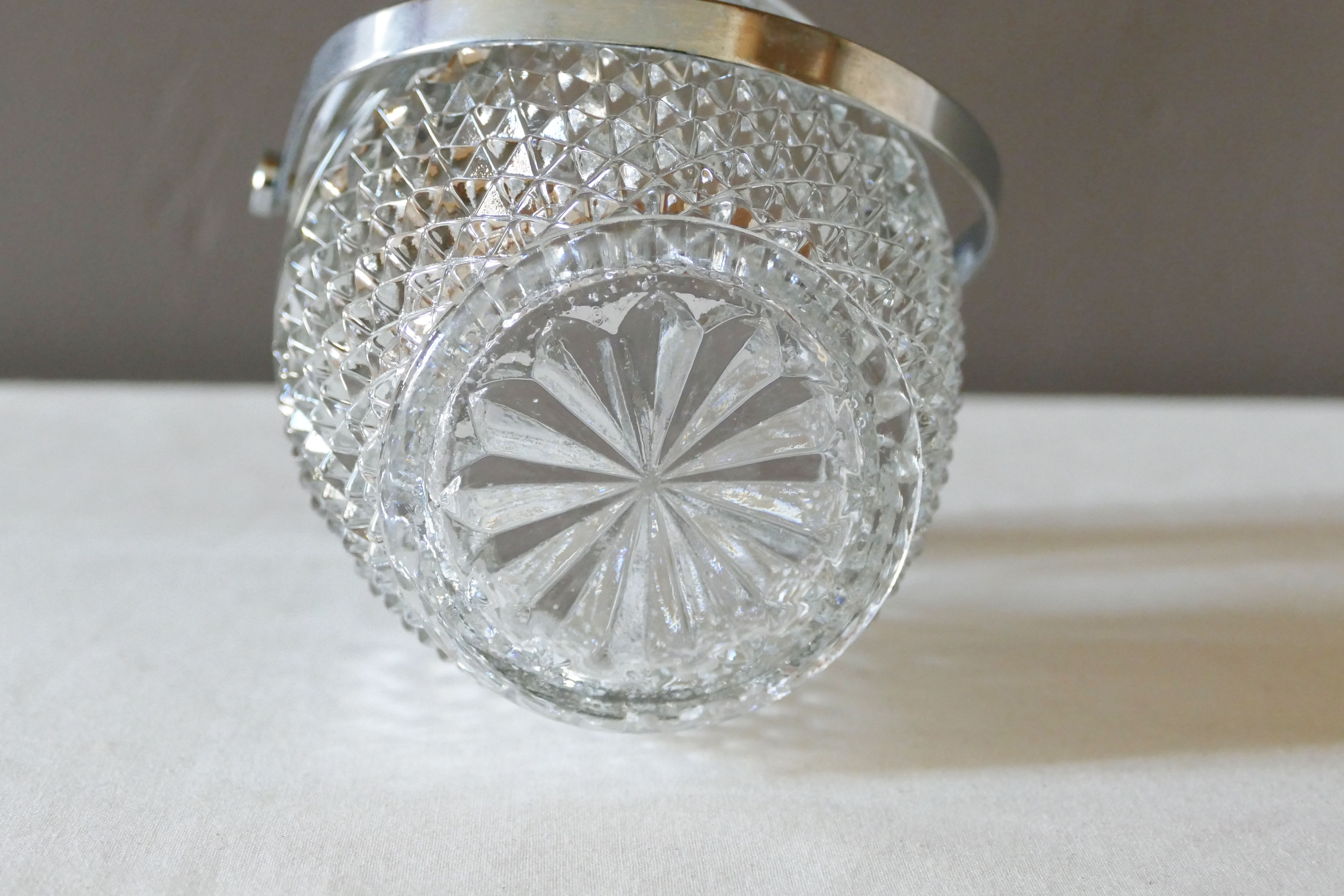 Vintage glass ice bucket stamped with a metal handle