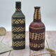 Set of 2 decorative vintage bottles covered with leather & wicker