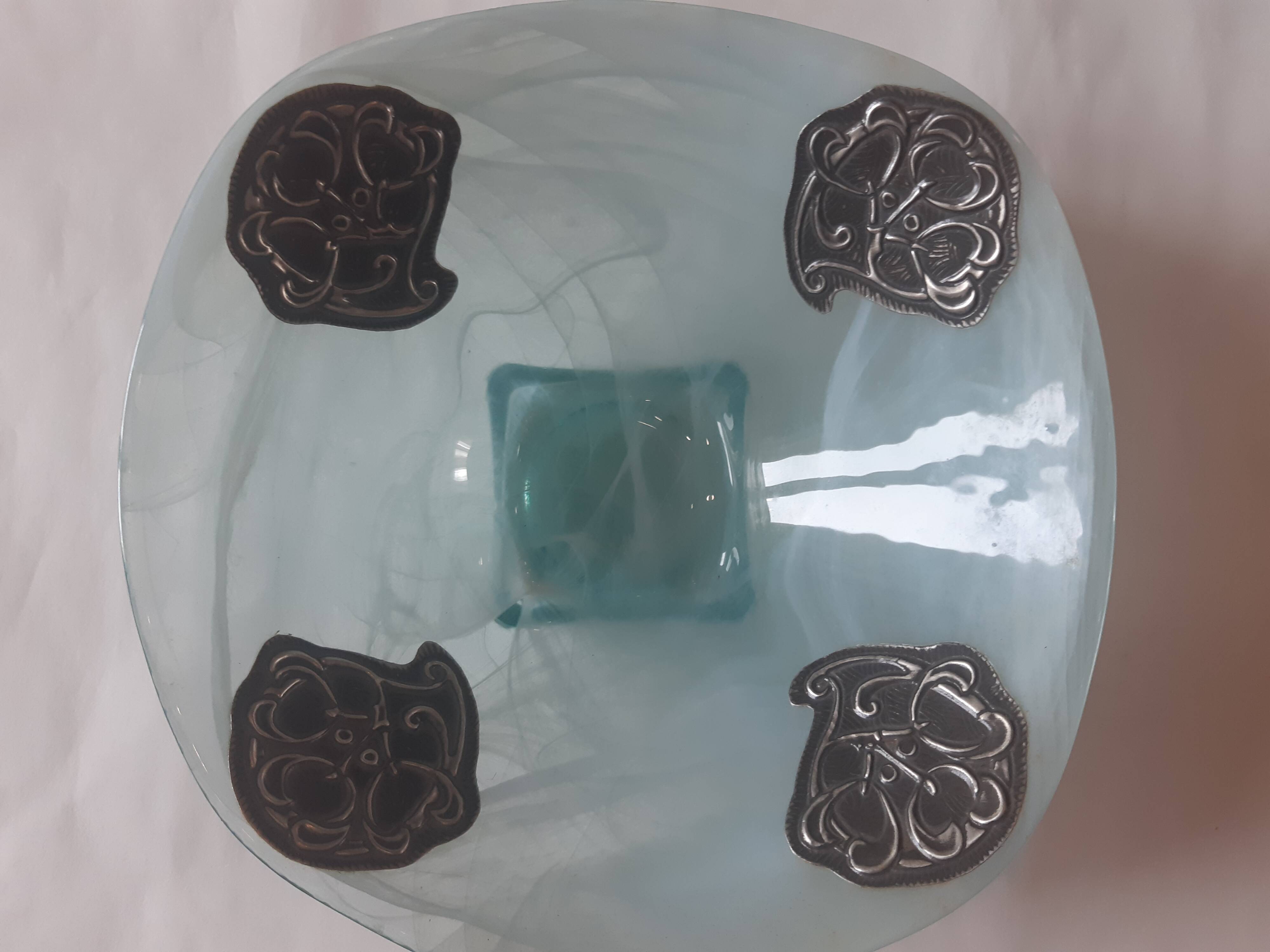 Handcrafted glass fruit bowl with ribbed design set with pewter medallions.