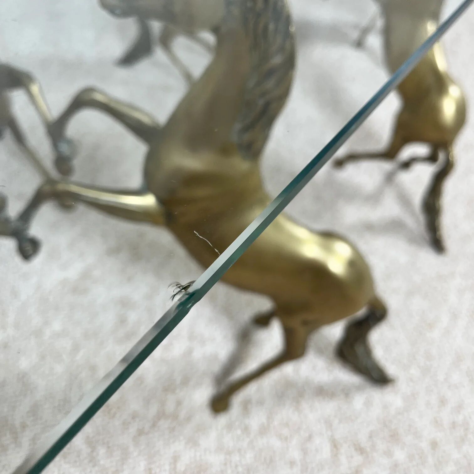 Hollywood Regency style coffee table, 6 patinated brass horses and glass top, 1970.