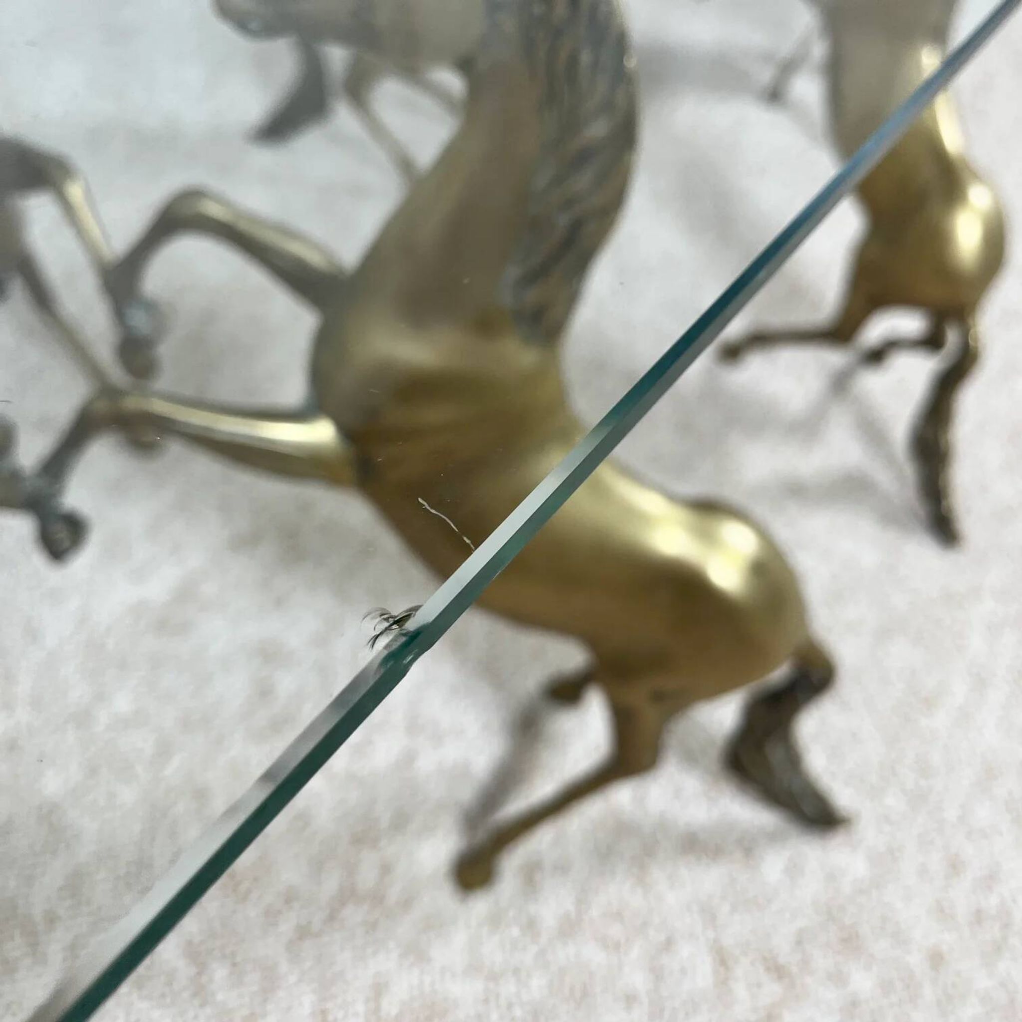 Hollywood Regency style coffee table, 6 patinated brass horses and glass top, 1970.