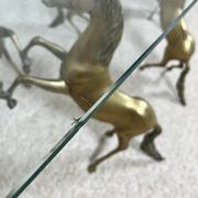 Hollywood Regency style coffee table, 6 patinated brass horses and glass top, 1970.