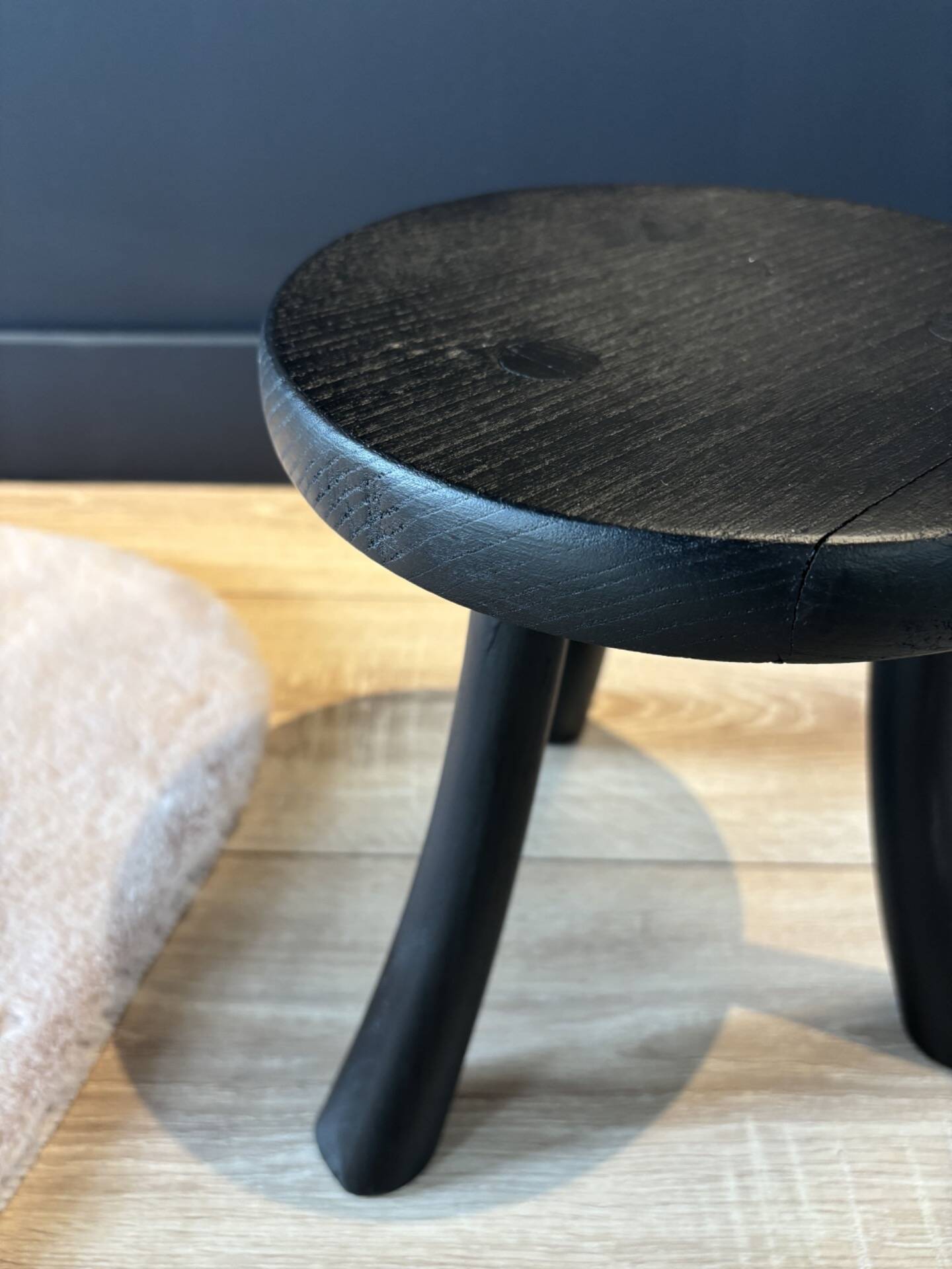 Small black wooden tripod stool