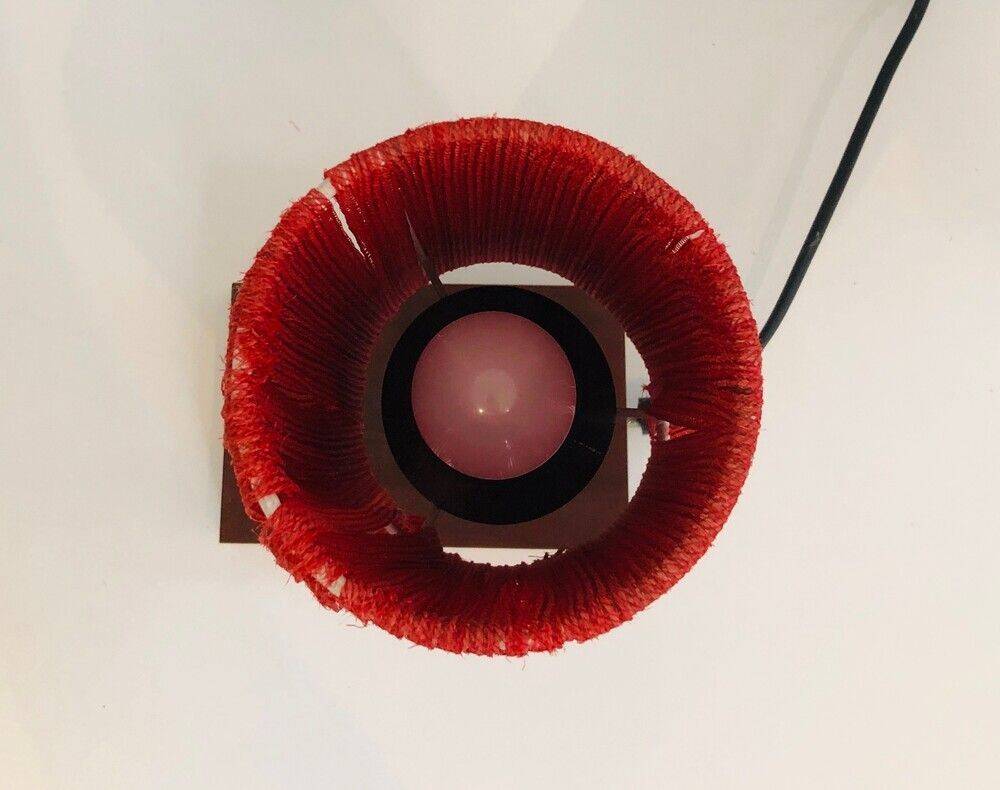 Small lamp made of wood, brass, and wool.