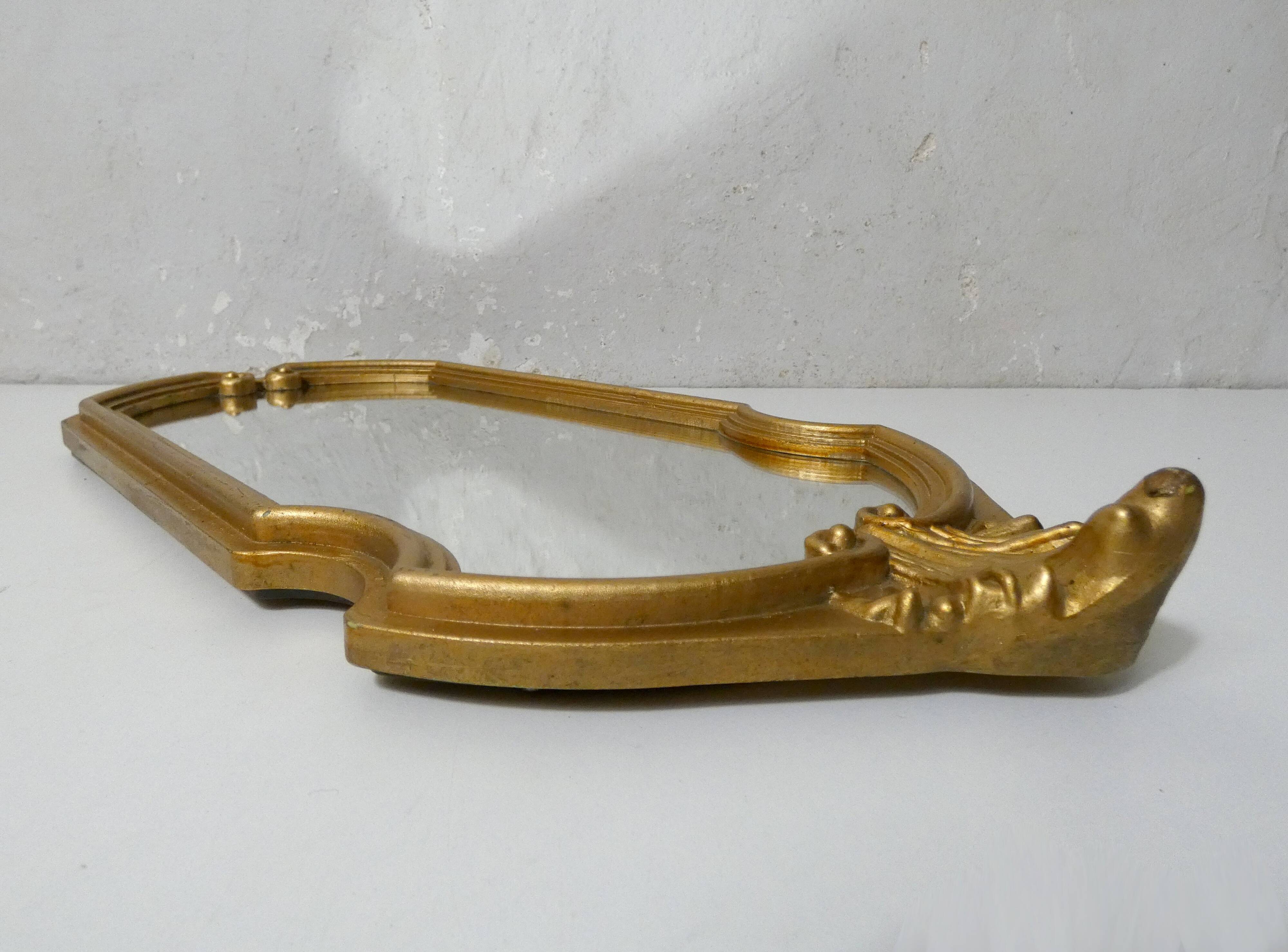 Antique Louis XV style mirror with a vintage carved gold frame.