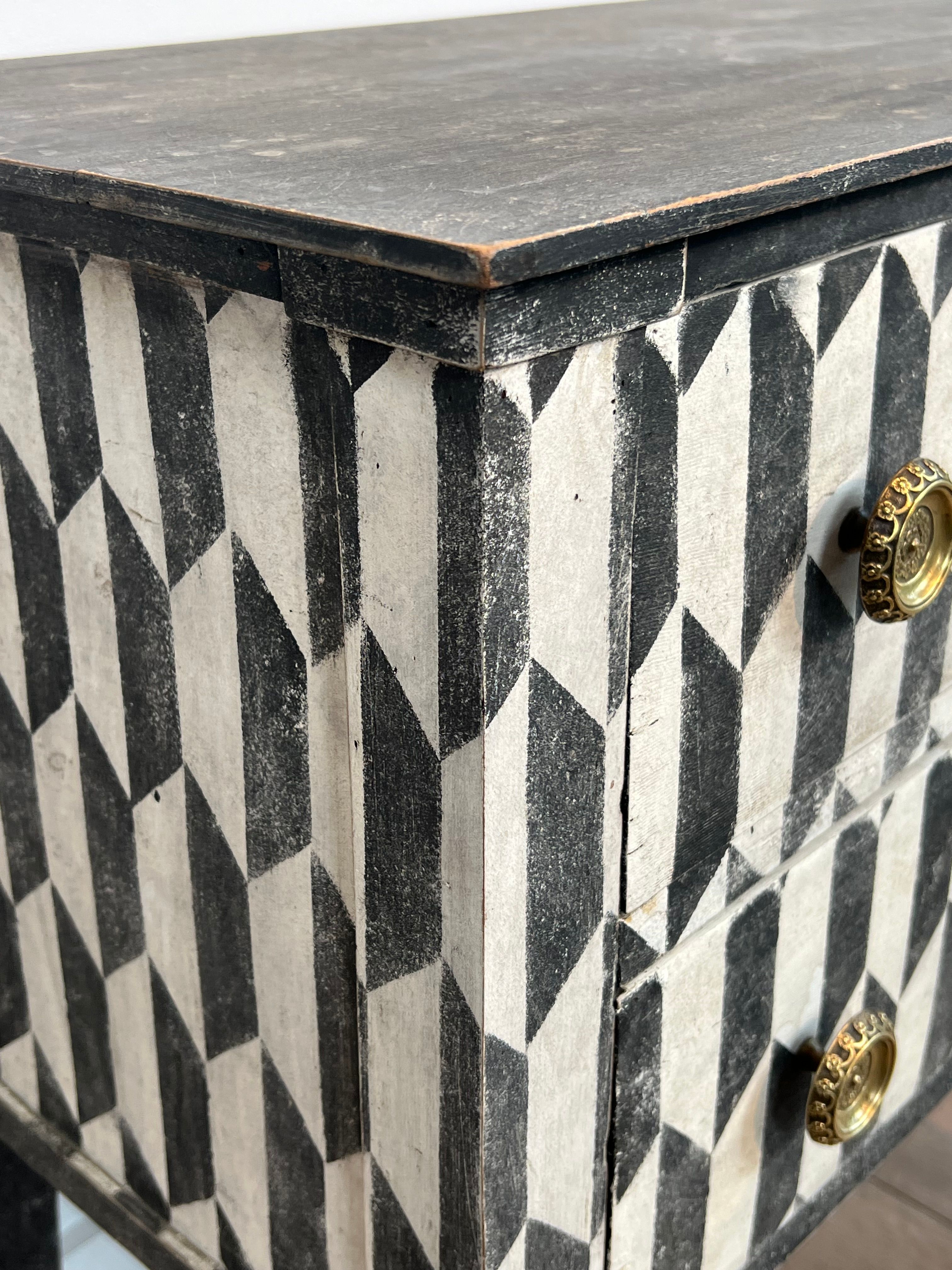 Small Italian chest of drawers with two drawers, patinated with a trompe-l'œil checkerboard pattern