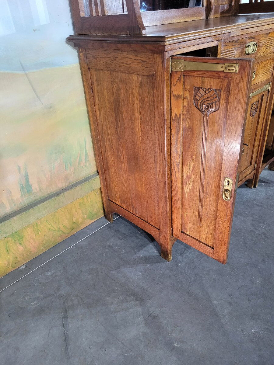 Glass-fronted oak sideboard from the Art Nouveau period.