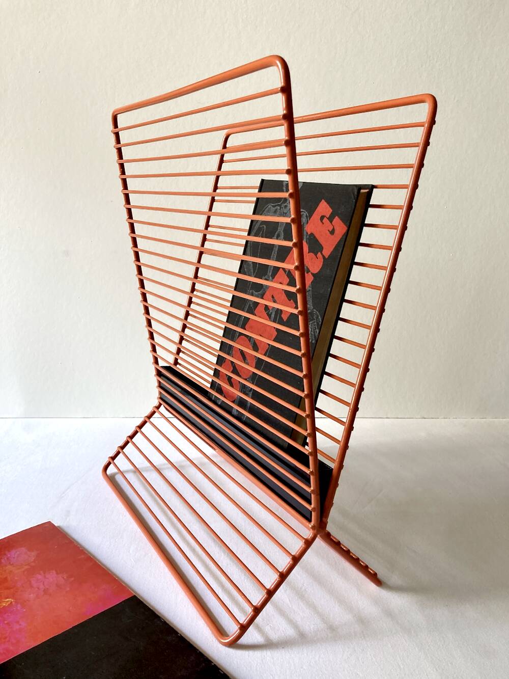 Wire metal magazine rack with triangular compartment, 1950s.