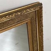 Small wooden mirror with gilded stucco in the Louis XVI style.