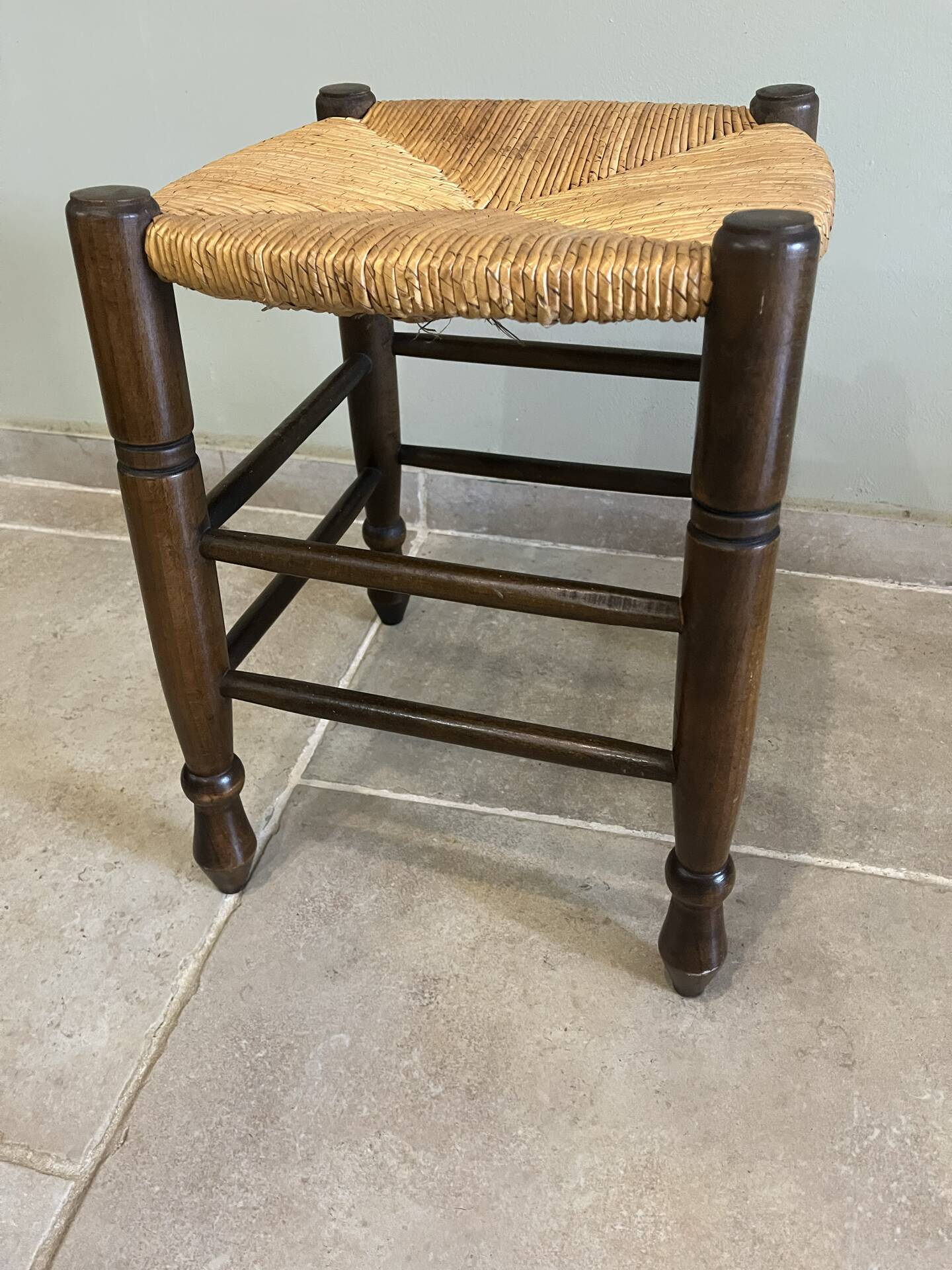 Wooden stool with a straw seat