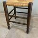 Wooden stool with a straw seat
